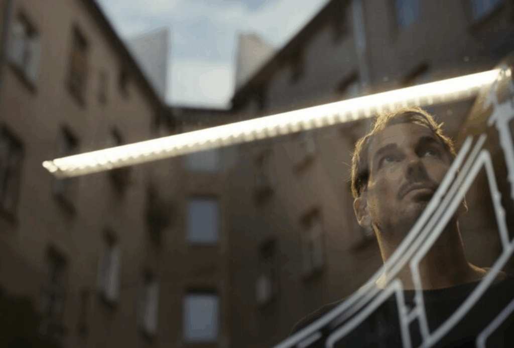 a man is looking on a appartement block probably called black box