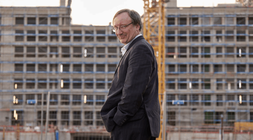 the main actor in front of a big construction