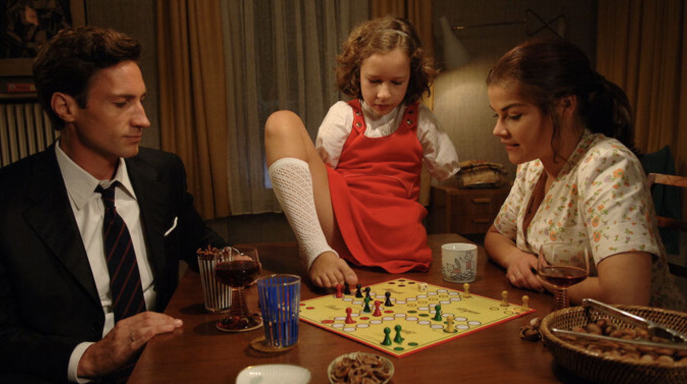 Thalomid Filmposter: A Family is sitting together at a table and is playing ludo